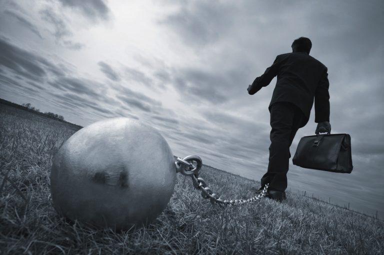 An executive strapped to an iron ball chain